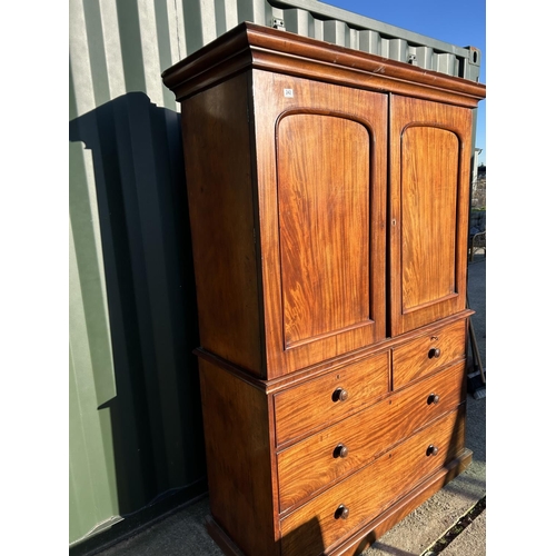 242 - A Victorian mahogany linen press, with a top section fitted with three slides over a four drawer bas... 