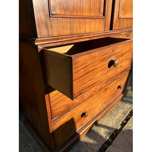 242 - A Victorian mahogany linen press, with a top section fitted with three slides over a four drawer bas... 