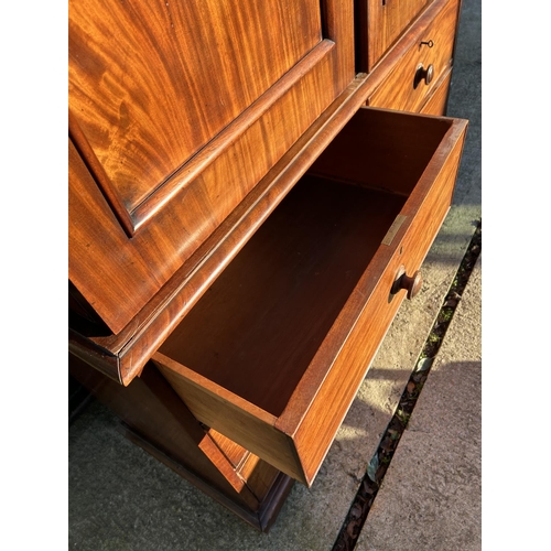 242 - A Victorian mahogany linen press, with a top section fitted with three slides over a four drawer bas... 