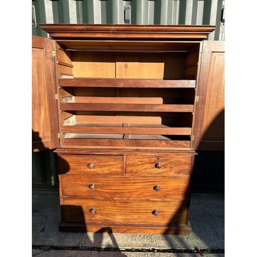 242 - A Victorian mahogany linen press, with a top section fitted with three slides over a four drawer bas... 