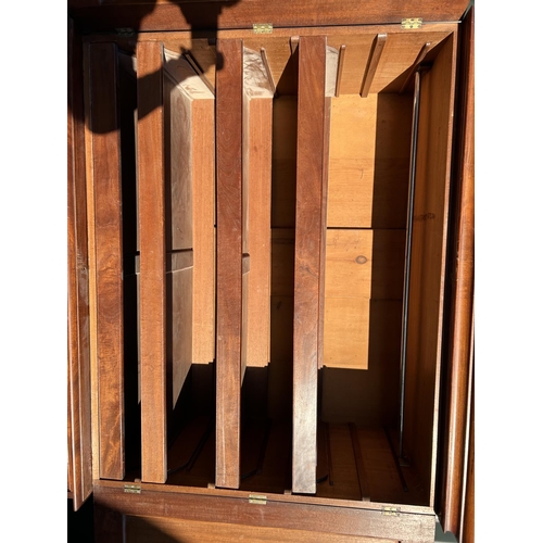 242 - A Victorian mahogany linen press, with a top section fitted with three slides over a four drawer bas... 