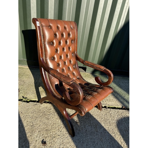 243 - A brown leather chesterfield slipper chair