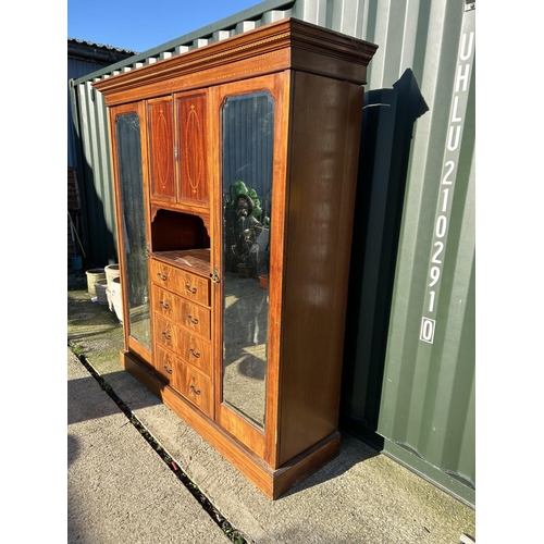 248 - A Edwardian mahogany inlaid triple compactum wardrobe with central linen cupboard and four drawers f... 