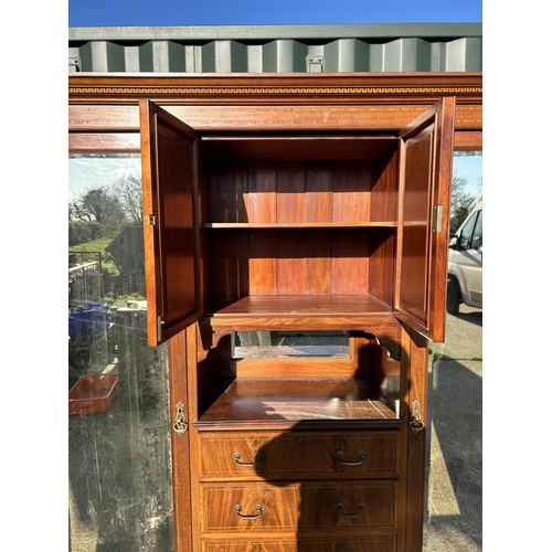 248 - A Edwardian mahogany inlaid triple compactum wardrobe with central linen cupboard and four drawers f... 