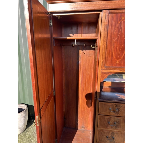 248 - A Edwardian mahogany inlaid triple compactum wardrobe with central linen cupboard and four drawers f... 