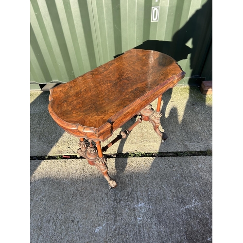 254 - A Victorian walnut fold over card table