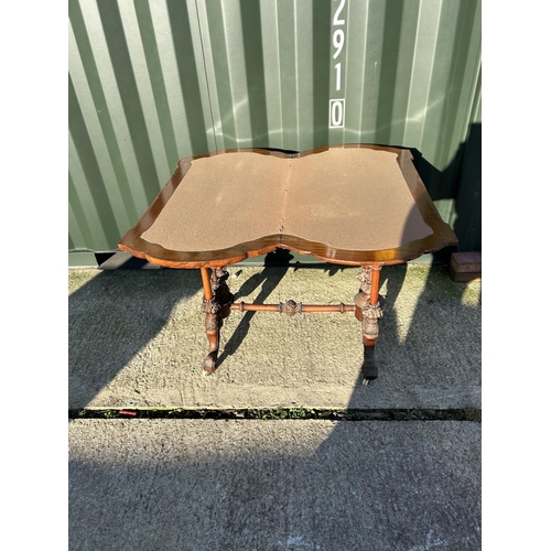 254 - A Victorian walnut fold over card table