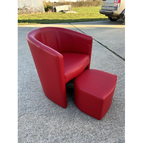 264 - A modern red leather effect tub chair with stool