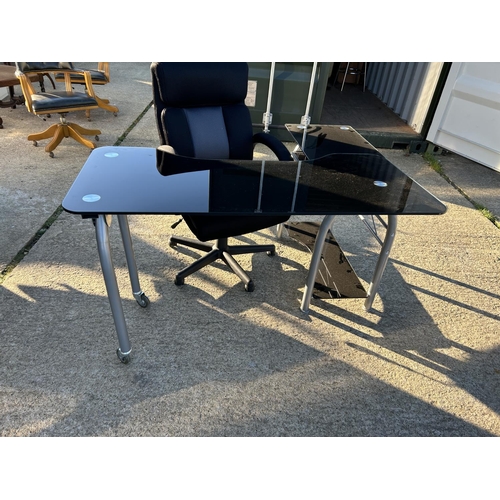 270 - A modern black glass swivel out workstation desk with desk chair