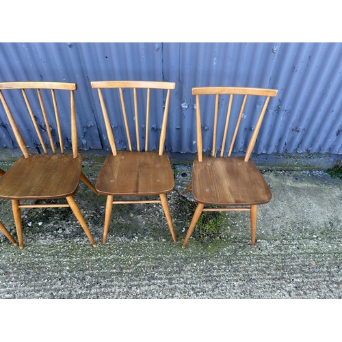 3 - A set of four Ercol light elm stickback chairs