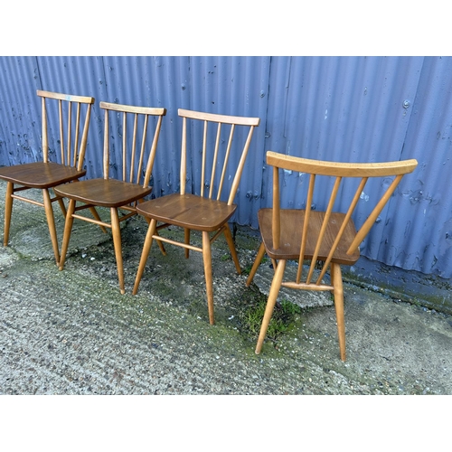 3 - A set of four Ercol light elm stickback chairs