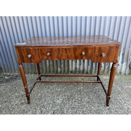 32 - A mahogany three drawer writing table STAMPED MORRIS GLASGOW 107x57x80