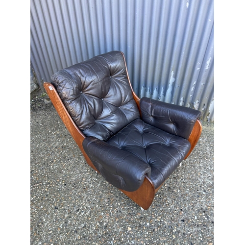 36 - A mid century teak framed g plan or similar armchair with brown leather upholstery