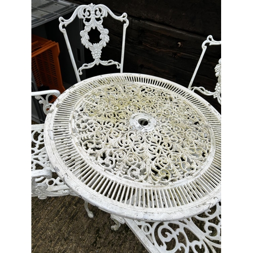 367 - An ornate white aluminium garden table with four matching chairs