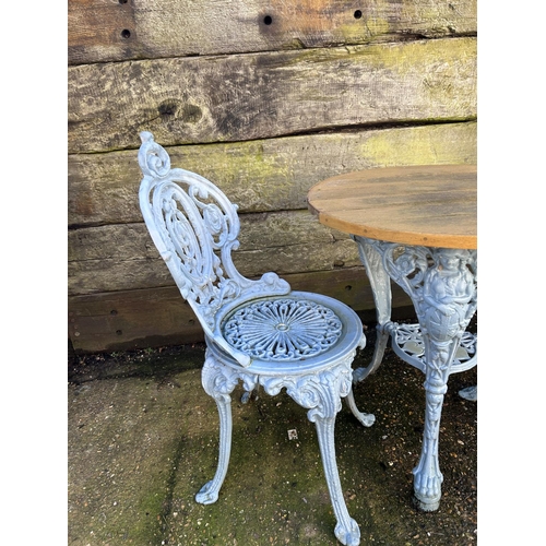 372 - A blue painted ornate iron based garden table with 2 chairs