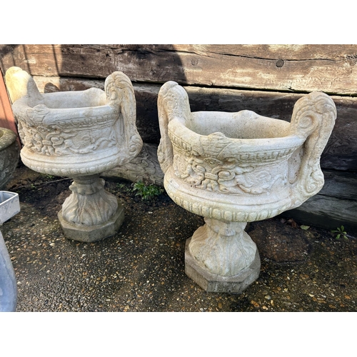 375 - A pair of fleur de lis concrete pedestal urns