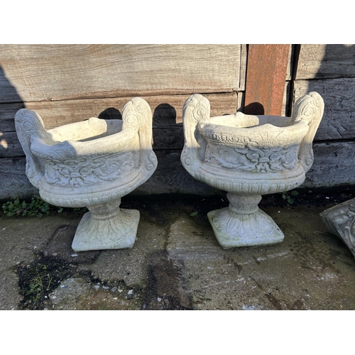 380 - A pair of fleur de lis concrete pedestal urns