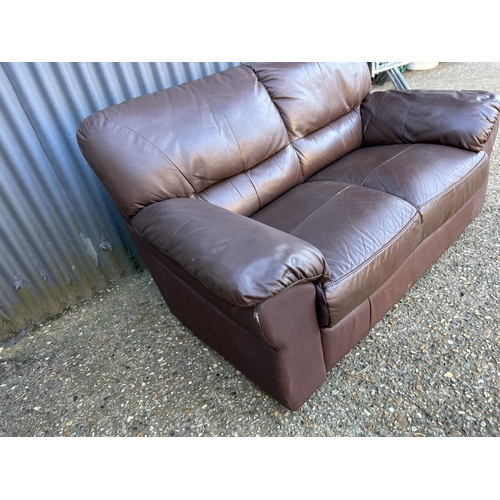 48 - A brown leather two seater sofa