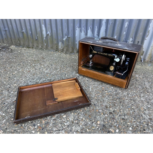 64 - A singer sewing machine in case