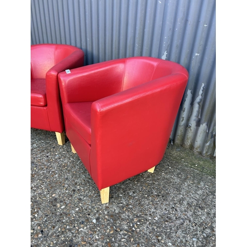 68 - A pair of modern red leather effect tub chairs
