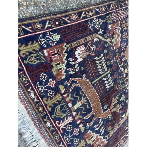 70 - A blue / brown animal pattern carpet 192x104