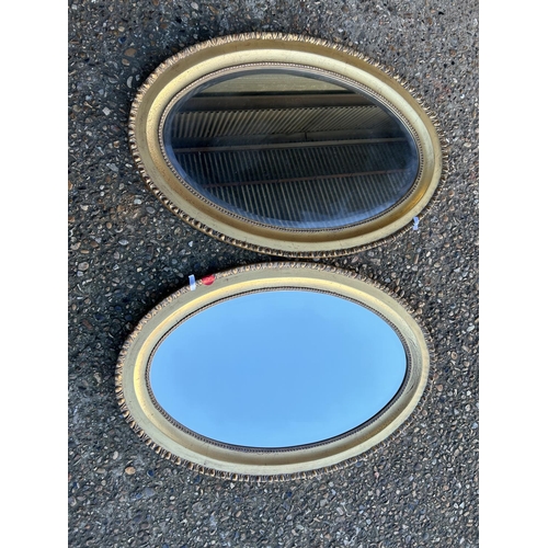 83 - A pair of oval mirrors with gold gilt frames 90x60