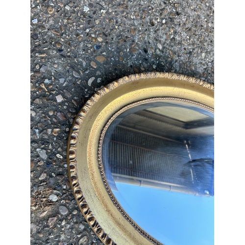 83 - A pair of oval mirrors with gold gilt frames 90x60