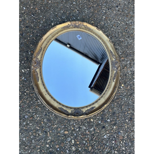 84 - A gold gilt framed oval mirror 75x70