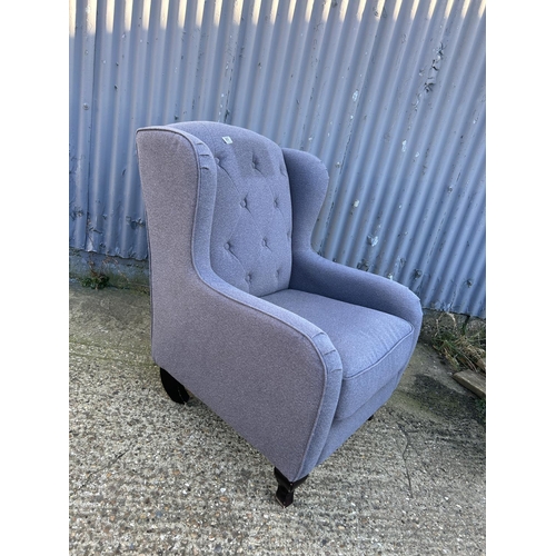 89 - A modern grey upholstered button back armchair