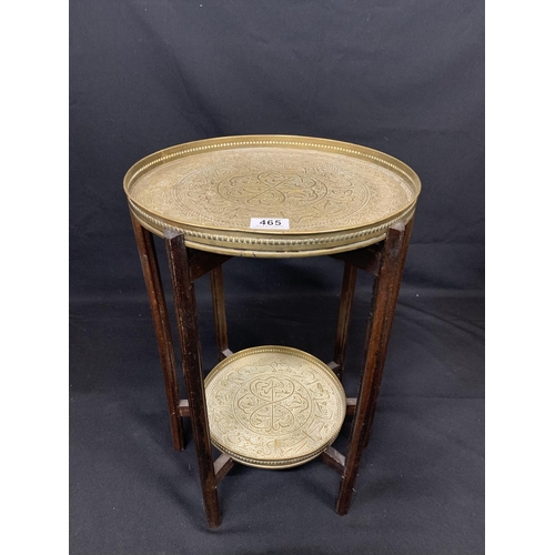 465 - Eastern brass two tier Table on six leg folding base, 33cms diameter, 52cms tall