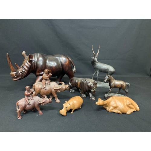 466 - Collection of eight carved wooden animal figures, Rhino 42 x 26cms