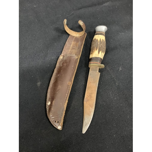 722 - Hunting Knife and leather sheath length 24 cms