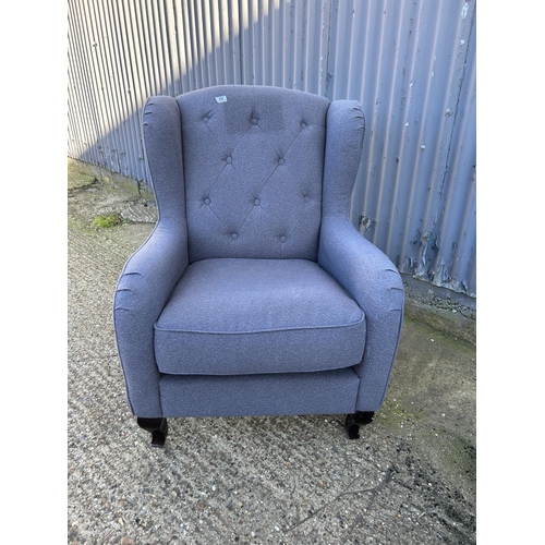 207 - A modern grey upholstered button back armchair