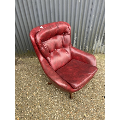 1 - A mid century red vinyl swivel lounge chair with teak four pointed base
