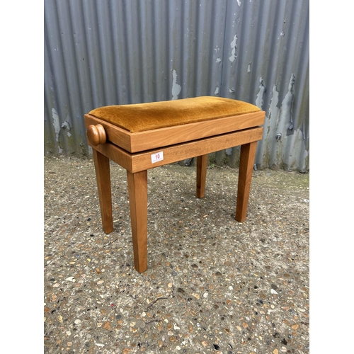 10 - An adjustable teak piano stool