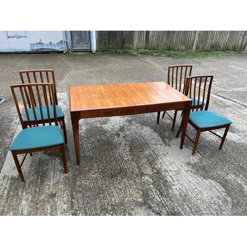 111 - A danish style mid century extending teak dining table together with four chairs 146x 77