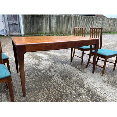 111 - A danish style mid century extending teak dining table together with four chairs 146x 77