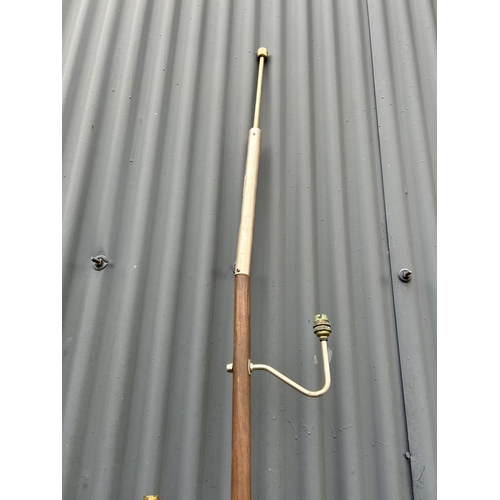 119 - A mid century teak portable light fitting with spring poles to top and bottom