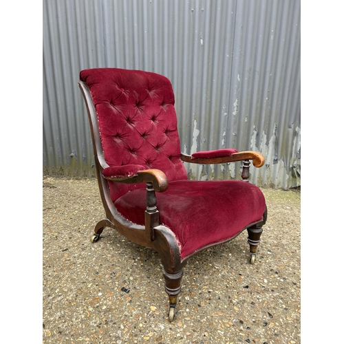 12 - A Victorian mahogany framed button back chair with maroon uoholstery