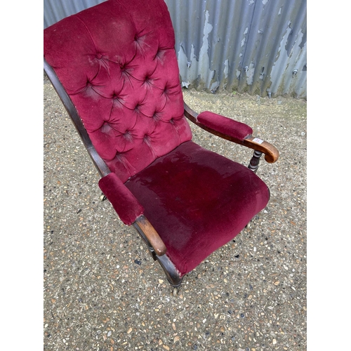 12 - A Victorian mahogany framed button back chair with maroon uoholstery
