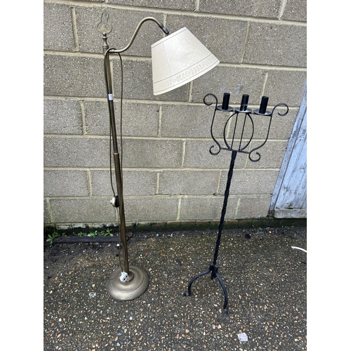 120 - A brass floor standing lamp together with a candle stand