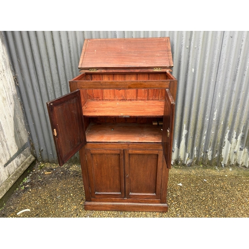 129 - A mahogany four door house keeping cupboard with lift up top  80x40x125