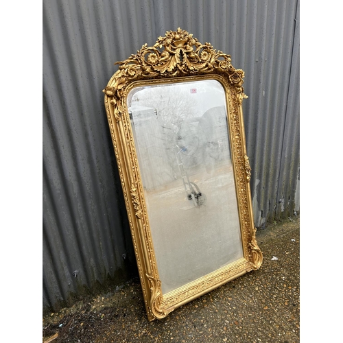 136 - A highly ornate gold gilt framed wall mirror with cherub decoration 80x 160
