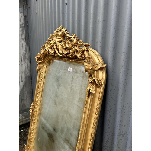 136 - A highly ornate gold gilt framed wall mirror with cherub decoration 80x 160