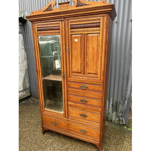 141 - An Edwardian oak combination wardrobe / chest with single mirror door and four drawers 107x46x200