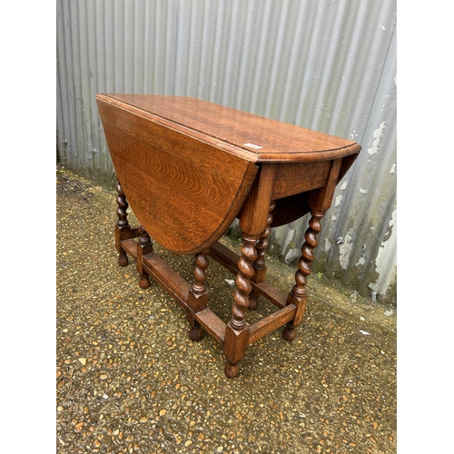142 - An oak barley twist gate-leg table