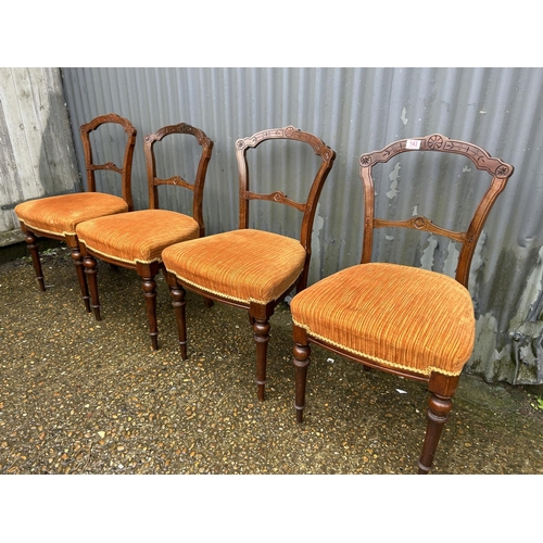 143 - An ornate set of four mahogany balloon back chairs with gold upholstered seats