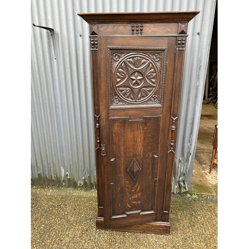 145 - A carved oak single door wardrobe 72x 40x200