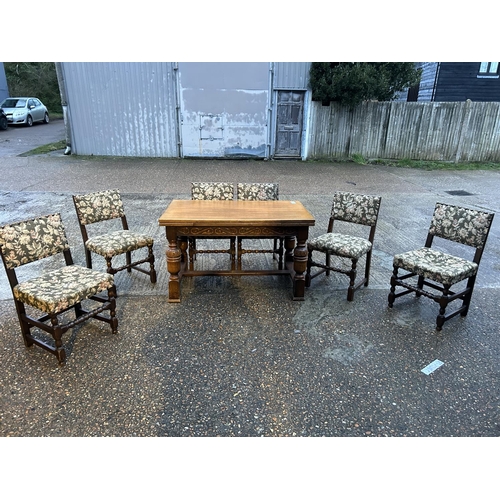 176 - An oak drawer leaf table with a set of six oak framed chairs 127x 77x 77