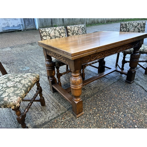176 - An oak drawer leaf table with a set of six oak framed chairs 127x 77x 77